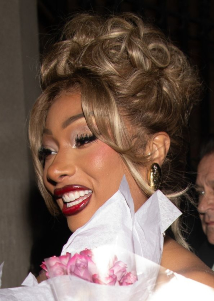 Megan Thee Stallion smiling in a blonde updo